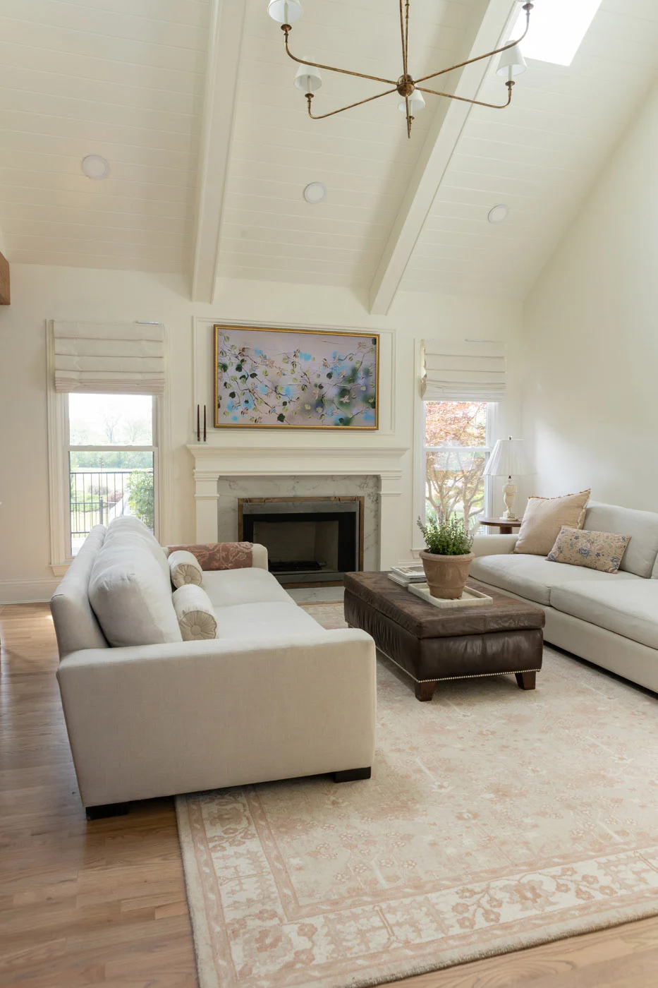 Riverview living room with vaulted ceiling and leather ottoman