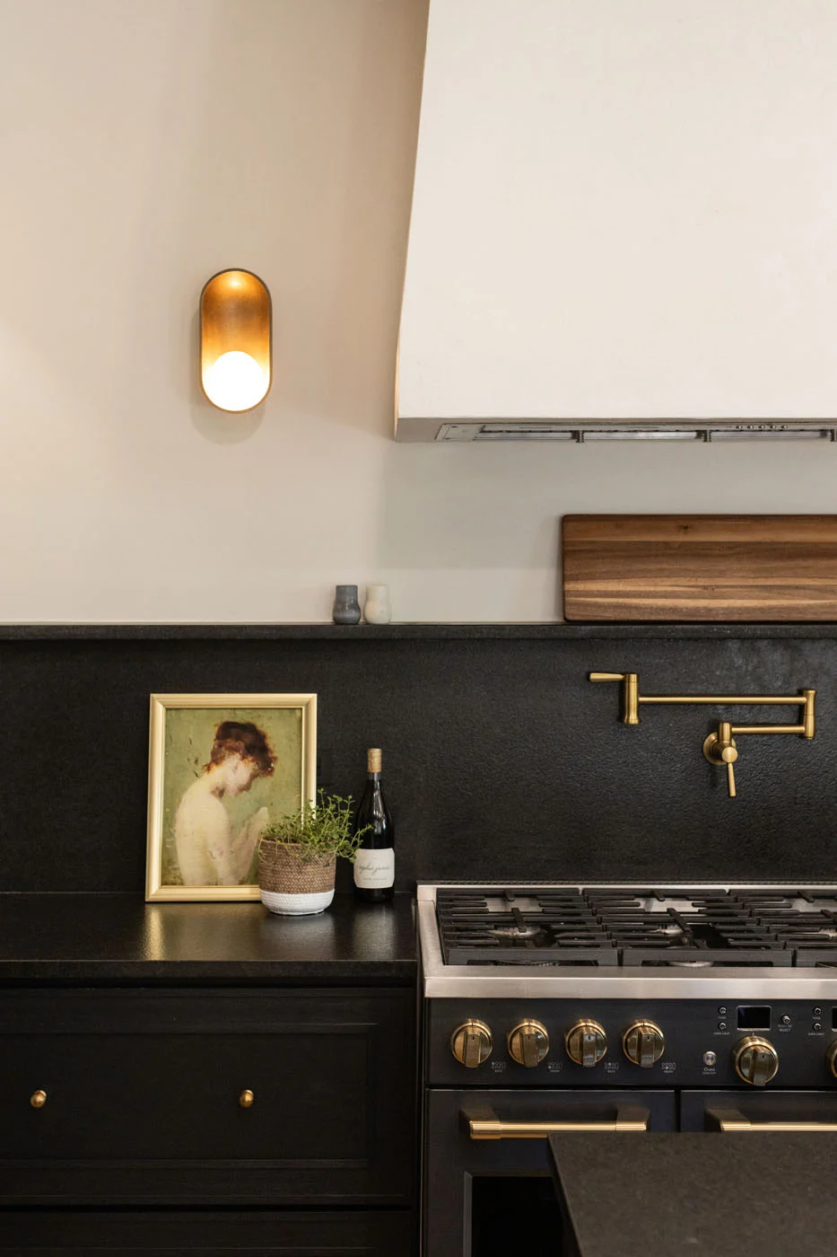 Seward Hall kitchen range with pot filler and brass sconce